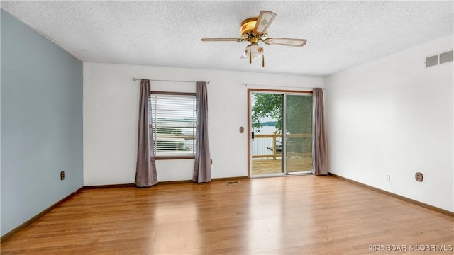 864 Four Waters Dr, Sunrise Beach, MO 65079 - unfurnished room with wood finished floors, a textured ceiling, ceiling fan, and baseboards