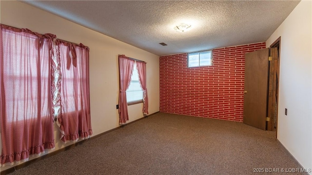 864 Four Waters Dr, Sunrise Beach, MO 65079 - spare room featuring a textured ceiling, brick wall, and carpet