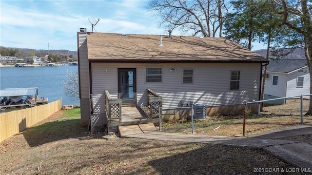 864 Four Waters Dr, Sunrise Beach, MO 65079 - view of front of property with a chimney, a water view, and central AC unit