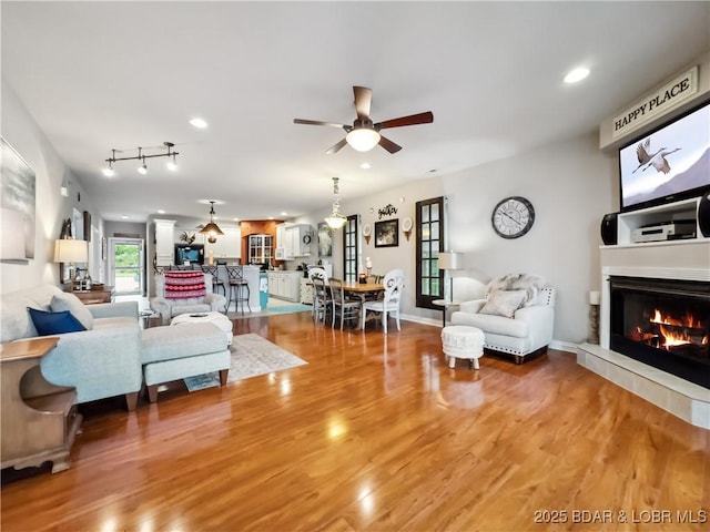 134 Heavenly Days Cir Unit 3A, Camdenton, MO 65020 - living room with ceiling fan, a glass covered fireplace, light wood-type flooring, and recessed lighting