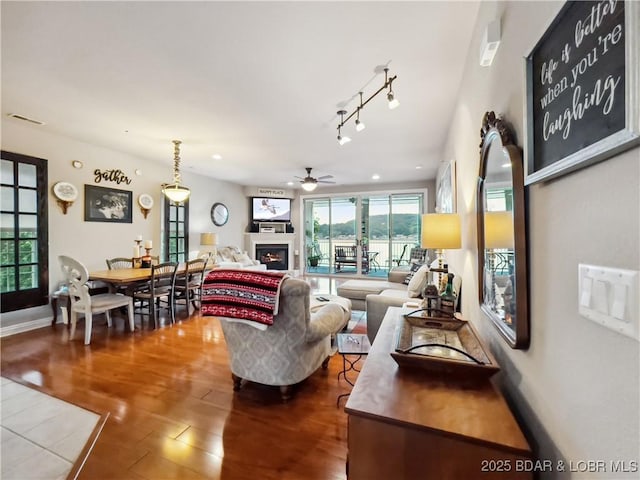 134 Heavenly Days Cir Unit 3A, Camdenton, MO 65020 - living room featuring ceiling fan, dark wood-style flooring, a lit fireplace, and recessed lighting