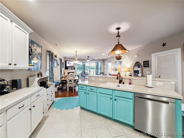 134 Heavenly Days Cir Unit 3A, Camdenton, MO 65020 - kitchen with dishwasher, a sink, blue cabinetry, decorative light fixtures, and light countertops