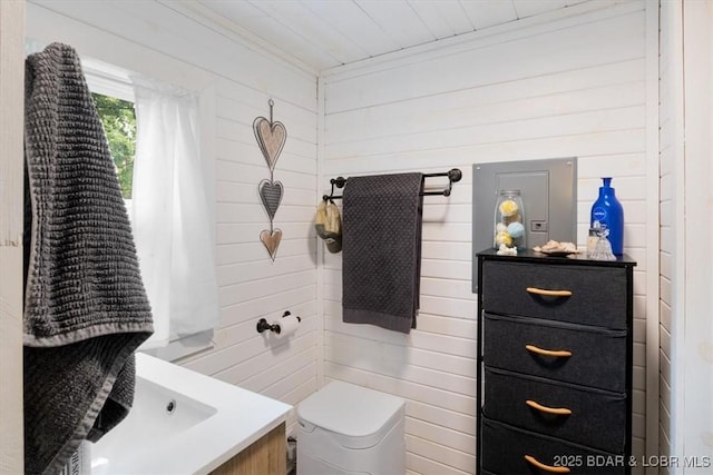 34546 Ivy Bend Rd, Stover, MO 65018 - bathroom with ornamental molding, vanity, toilet, and wood walls