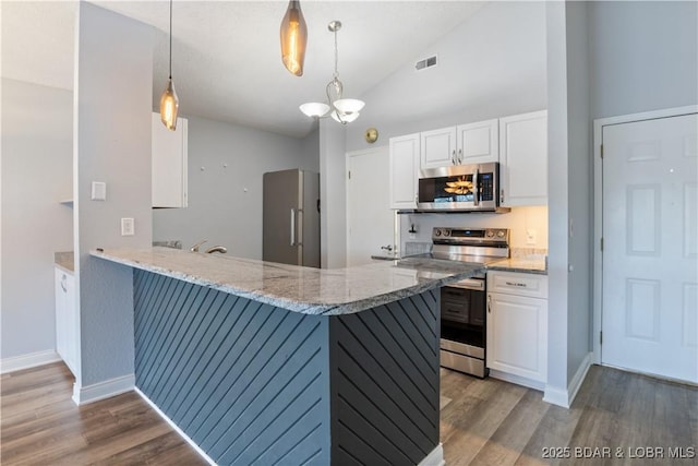 98 Jonathan Dr Unit 4C, Lake Ozark, MO 65049 - kitchen with appliances with stainless steel finishes, white cabinets, wood finished floors, light stone counters, and high vaulted ceiling