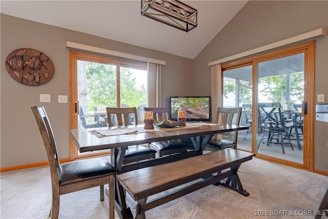42 Rhine River Rd, Sunrise Beach, MO 65079 - dining area featuring light colored carpet, lofted ceiling, healthy amount of natural light, and baseboards