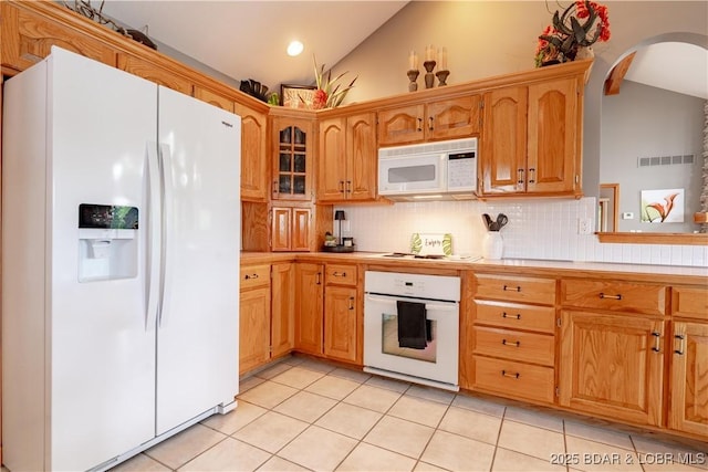 42 Rhine River Rd, Sunrise Beach, MO 65079 - kitchen featuring white appliances, lofted ceiling, tasteful backsplash, light tile patterned floors, and arched walkways