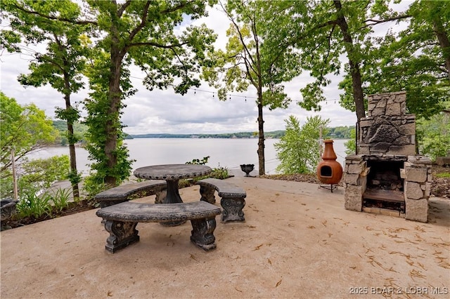 42 Rhine River Rd, Sunrise Beach, MO 65079 - view of yard with a patio, an outdoor stone fireplace, and a water view