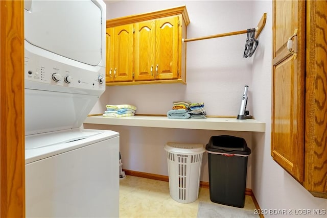 42 Rhine River Rd, Sunrise Beach, MO 65079 - washroom with stacked washing machine and dryer, cabinet space, light floors, and baseboards