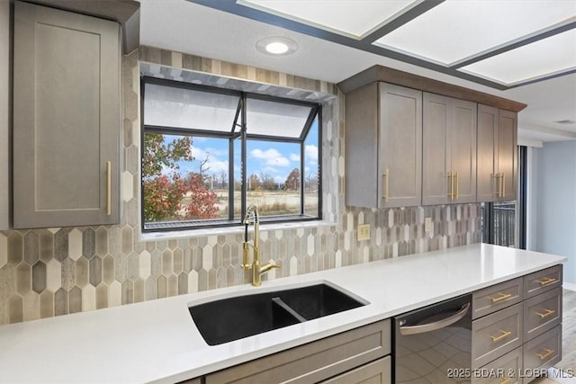 37 La Jolla Dr Unit 3C, Lake Ozark, MO 65049 - kitchen featuring stainless steel dishwasher, a sink, decorative backsplash, light countertops, and gray cabinets