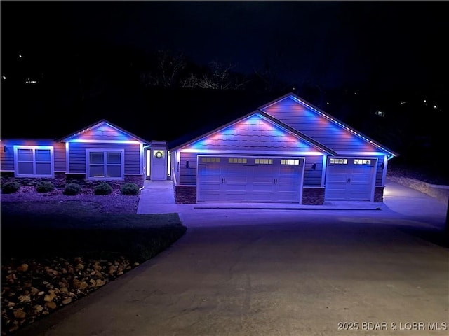 866 Fontana Ln, Linn Creek, MO 65052 - view of front facade featuring concrete driveway, stone siding, and a garage