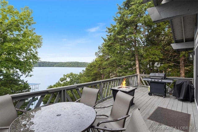 73 Ship Dock Ln, Osage Beach, MO 65065 - wooden terrace featuring a water view, an outdoor fire pit, outdoor dining area, and grilling area