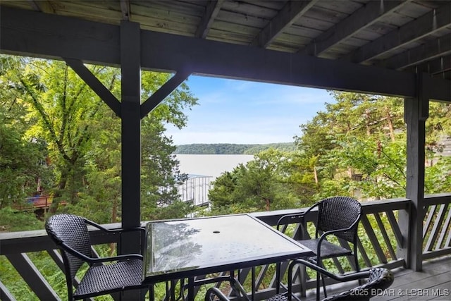 73 Ship Dock Ln, Osage Beach, MO 65065 - balcony featuring outdoor dining area, a view of trees, and a water view