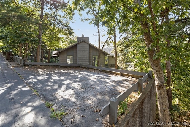 73 Ship Dock Ln, Osage Beach, MO 65065 - view of side of property featuring a chimney