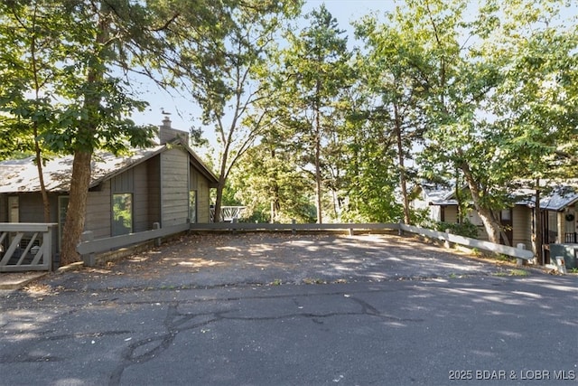 73 Ship Dock Ln, Osage Beach, MO 65065 - view of property exterior with a chimney