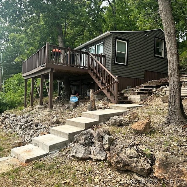 202 Gold Lane Cv, Sunrise Beach, MO 65079 - view of front facade featuring stairs and a wooden deck