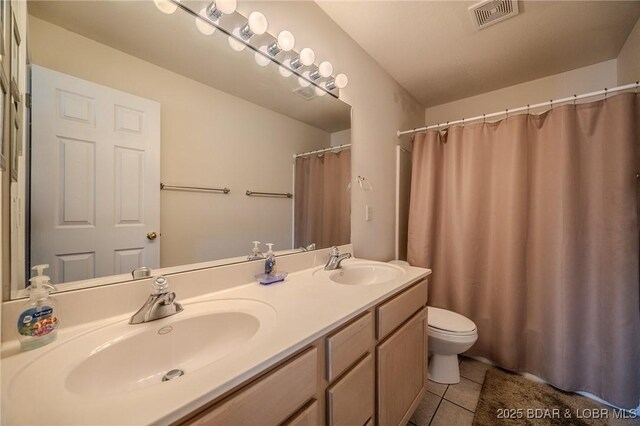 272 Cedar Glen Dr Unit 3A, Camdenton, MO 65020 - full bath with tile patterned floors, double vanity, toilet, and curtained shower