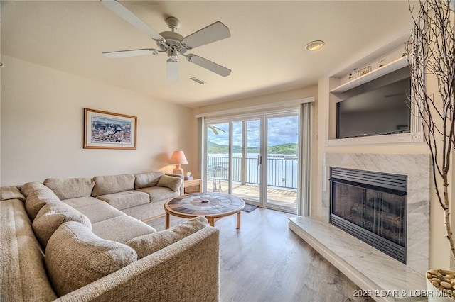 272 Cedar Glen Dr Unit 3A, Camdenton, MO 65020 - living room with wood finished floors, ceiling fan, and a fireplace