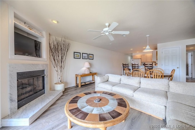 272 Cedar Glen Dr Unit 3A, Camdenton, MO 65020 - living room featuring light wood-style floors, a fireplace, a ceiling fan, recessed lighting, and baseboards