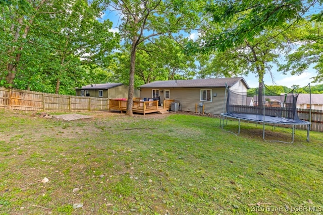 135 Tonka St, Camdenton, MO 65020 - view of yard with a trampoline, a wooden deck, and central air condition unit