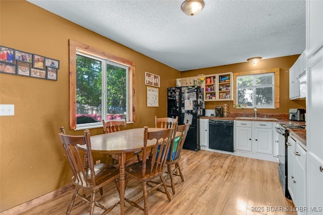 135 Tonka St, Camdenton, MO 65020 - dining room with light wood-type flooring and a textured ceiling