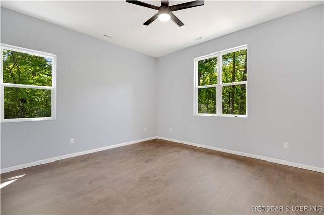 19580 Wonderland Rd, Rocky Mount, MO 65072 - spare room featuring ceiling fan, baseboards, and wood finished floors