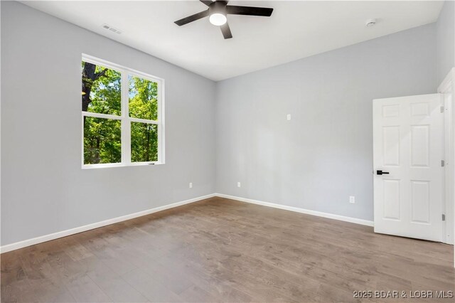 19580 Wonderland Rd, Rocky Mount, MO 65072 - spare room featuring ceiling fan, baseboards, and wood finished floors