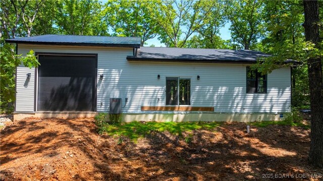 19580 Wonderland Rd, Rocky Mount, MO 65072 - rear view of house with a garage