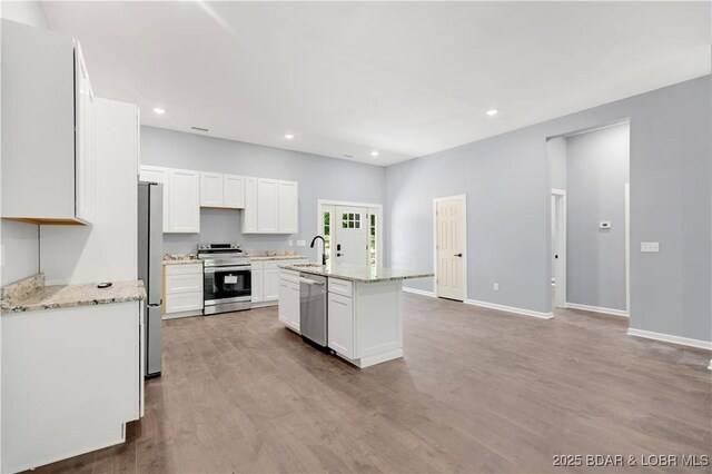 19580 Wonderland Rd, Rocky Mount, MO 65072 - kitchen featuring stainless steel appliances, white cabinetry, a sink, wood finished floors, and baseboards