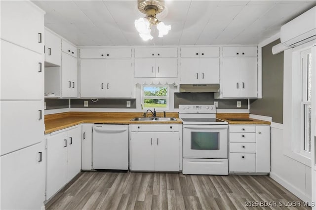 47 Hittridge Rd, Eldon, MO 65026 - kitchen with white appliances, a sink, a wall mounted air conditioner, under cabinet range hood, and wood finished floors