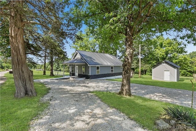 47 Hittridge Rd, Eldon, MO 65026 - view of front of house with gravel driveway, a front yard, and metal roof