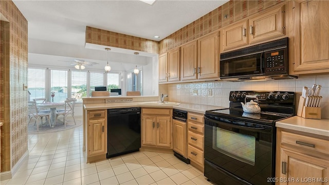 441 Northport Dr Unit 441, Lake Ozark, MO 65049 - kitchen with black appliances, a sink, light countertops, a peninsula, and light tile patterned floors