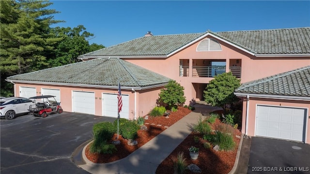 441 Northport Dr Unit 441, Lake Ozark, MO 65049 - view of front of home with a tile roof, stucco siding, and driveway