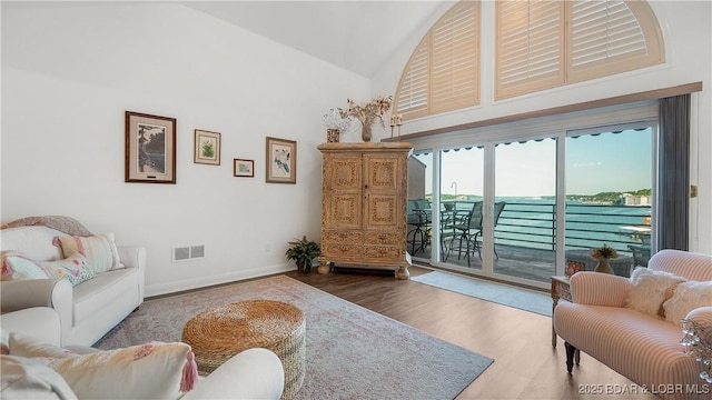 441 Northport Dr Unit 441, Lake Ozark, MO 65049 - living area featuring wood finished floors, high vaulted ceiling, and baseboards