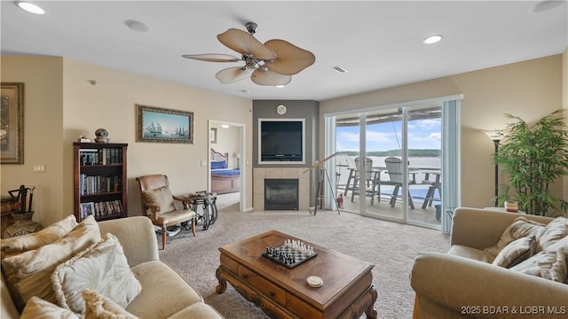 1230 Lands End Pkwy Unit 304, Osage Beach, MO 65065 - living room featuring light carpet, a ceiling fan, a tiled fireplace, and recessed lighting