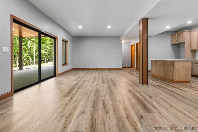 55 Turn Bridge Ln, Porto Cima, MO 65079 - unfurnished living room with light wood-style flooring, recessed lighting, and baseboards
