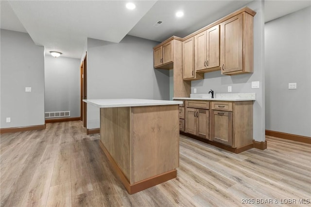 55 Turn Bridge Ln, Porto Cima, MO 65079 - kitchen with light wood-type flooring, light countertops, baseboards, and recessed lighting