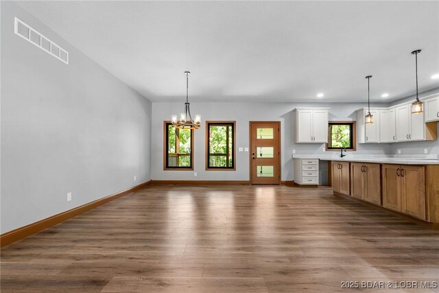 55 Turn Bridge Ln, Porto Cima, MO 65079 - kitchen with dark wood finished floors, recessed lighting, a sink, baseboards, and hanging light fixtures