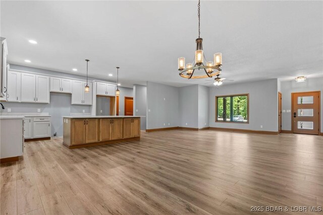 55 Turn Bridge Ln, Porto Cima, MO 65079 - kitchen featuring a chandelier, light wood-style floors, recessed lighting, baseboards, and white cabinets