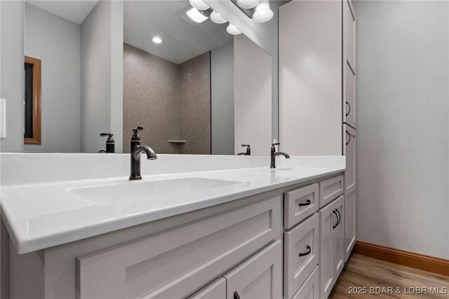 55 Turn Bridge Ln, Porto Cima, MO 65079 - bathroom featuring double vanity, wood finished floors, and baseboards