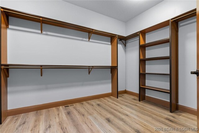 55 Turn Bridge Ln, Porto Cima, MO 65079 - spacious closet featuring light wood-style floors