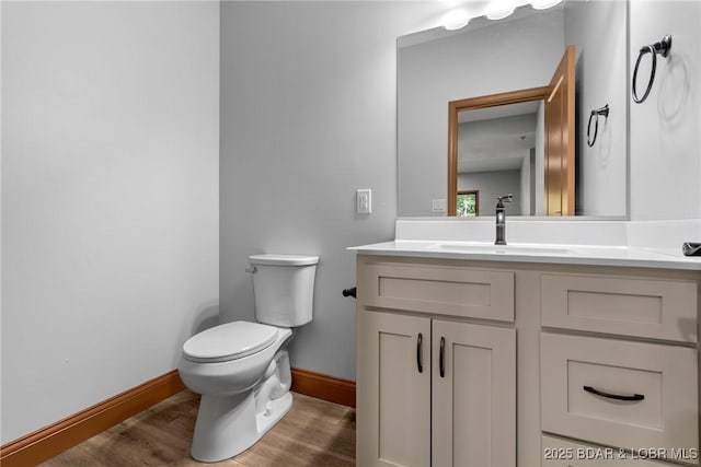 55 Turn Bridge Ln, Porto Cima, MO 65079 - bathroom featuring vanity, toilet, baseboards, and wood finished floors