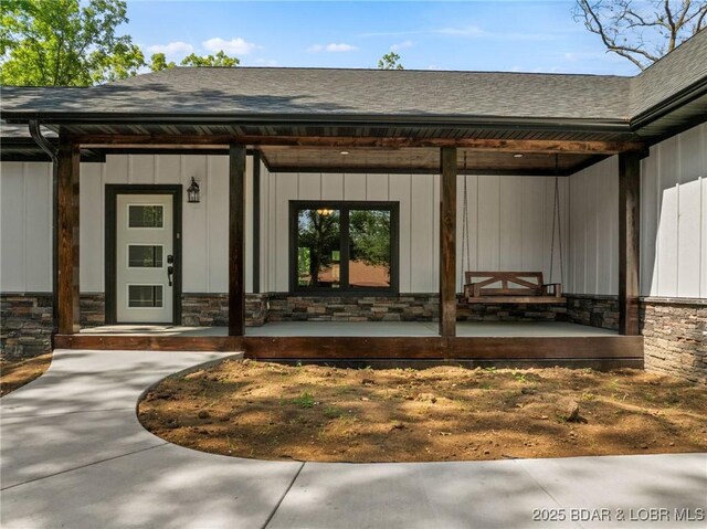 55 Turn Bridge Ln, Porto Cima, MO 65079 - doorway to property with stone siding, a porch, and a shingled roof