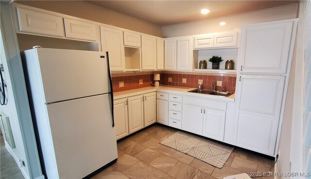 44 Port Bagnell Rd, Eldon, MO 65026 - kitchen featuring freestanding refrigerator, a sink, open shelves, decorative backsplash, and light countertops