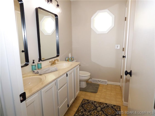 44 Port Bagnell Rd, Eldon, MO 65026 - bathroom featuring toilet, double vanity, baseboards, and tile patterned floors