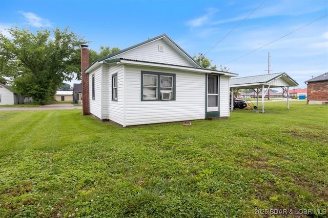 413 E 3rd St, Eldon, MO 65026 - rear view of house featuring a yard, a carport, and a chimney