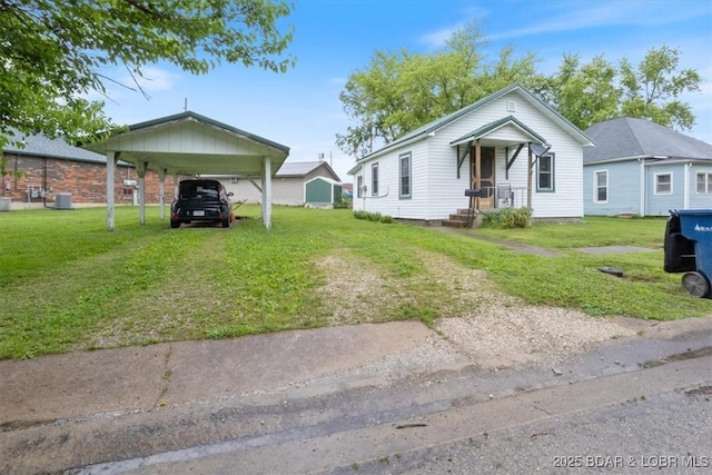 413 E 3rd St, Eldon, MO 65026 - view of front of house with a front yard, a carport, and driveway