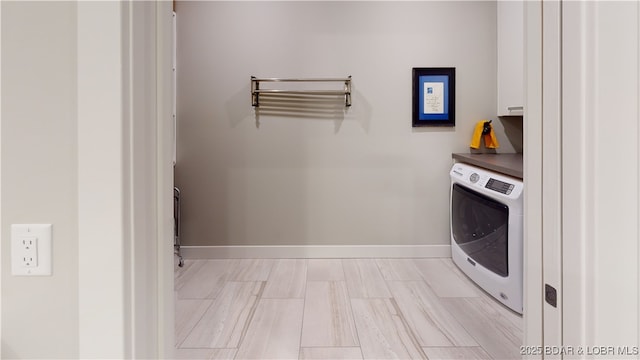 481 Comanche Rd, Lake Ozark, MO 65049 - laundry room with washer / dryer, cabinet space, and baseboards