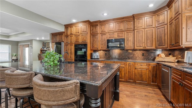 149 Snead Cir, Lake Ozark, MO 65049 - kitchen with black appliances, a sink, light wood finished floors, decorative backsplash, and recessed lighting