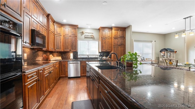 149 Snead Cir, Lake Ozark, MO 65049 - kitchen with a sink, black appliances, light wood-style flooring, tasteful backsplash, and recessed lighting