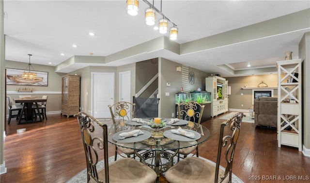 149 Snead Cir, Lake Ozark, MO 65049 - dining area featuring baseboards, hardwood / wood-style floors, a tray ceiling, and recessed lighting